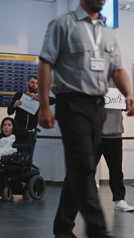man holding name sign in airport