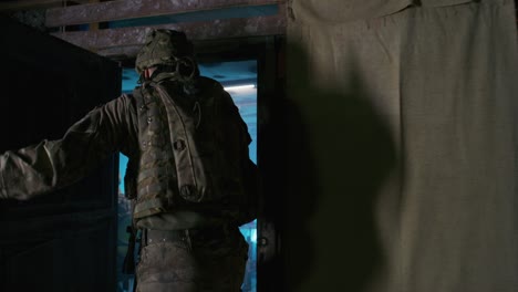 soldier of military intelligence entering base cabin