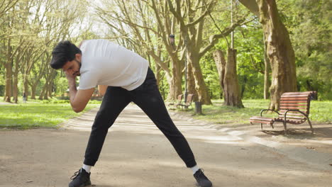 man stretching in a park