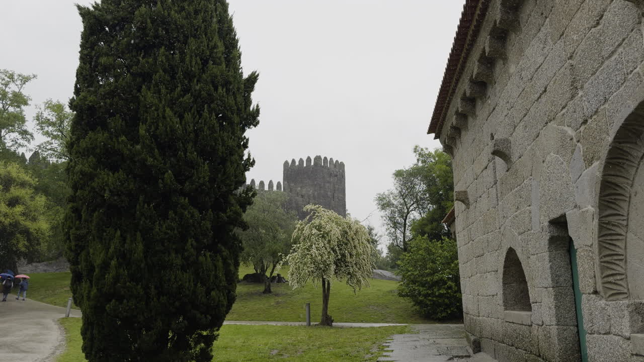 Gardens Outside Of Guimaraes Castle Next To Stone Cabin And Multiple Trees