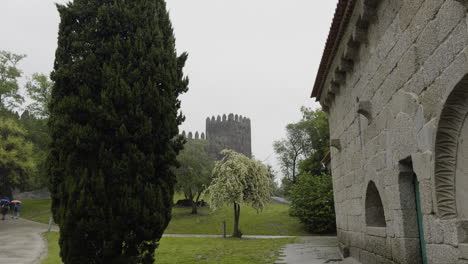 gardens outside of guimaraes castle next to stone cabin and multiple trees