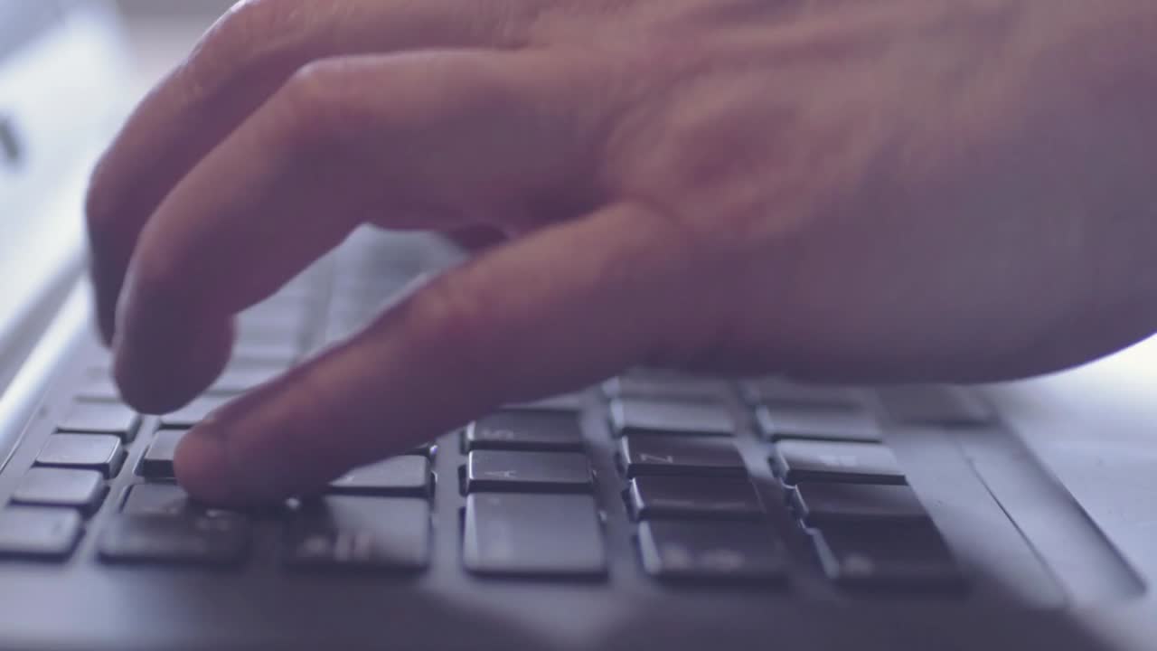 manos escribiendo en una computadora portátil