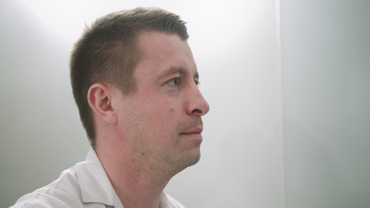 Close-up of a man in a white coat