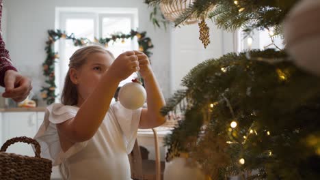 father and daughter decorating the christmas tree