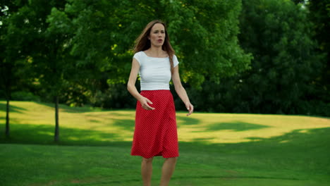 Mother-talking-with-daughter-in-park.-Woman-and-girl-playing-frisbee-in-meadow