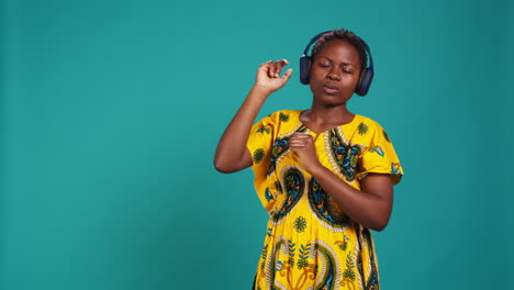 carefree relaxed woman listening to music and dancing in the studio