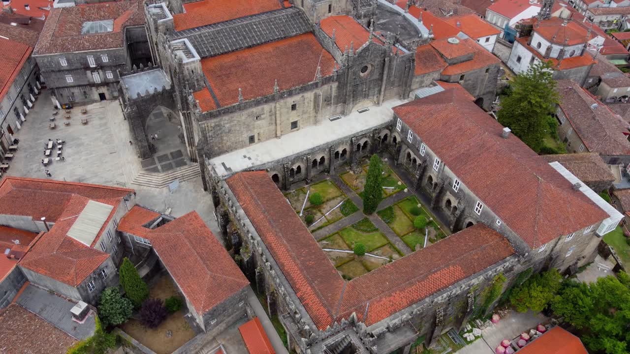 4K drone circling flight over Tui Cathedral in Galicia, Spain, cinematic aerial view of medieval cloister, historic architecture and old town surroundings