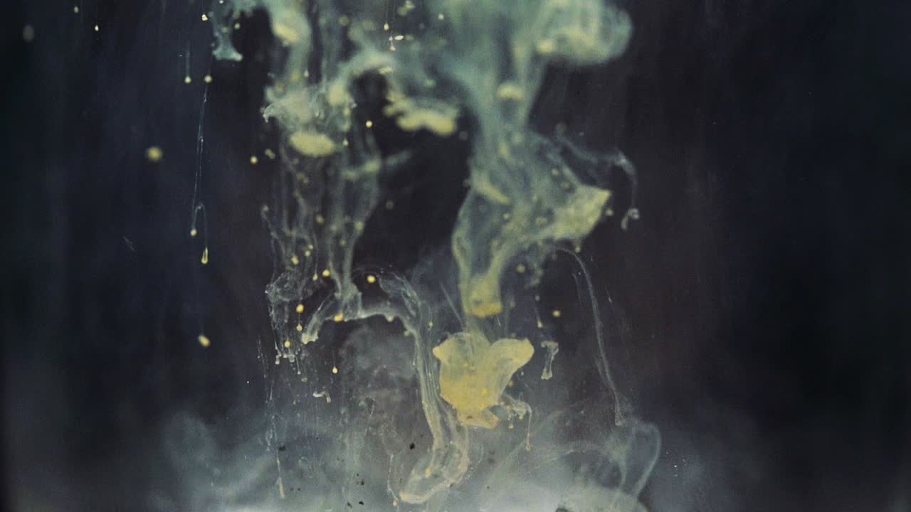 Colored paint floating in darkish water tank. Stable shot with the Sony a7iii