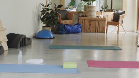 general view of empty pilates rehabilitation room with exercise tools and mats