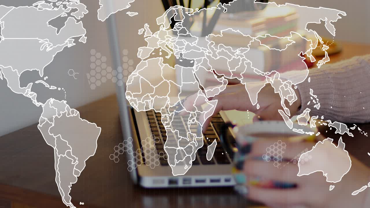 Tech worker typing at laptop on desk initiating world map expanding with hex data for analysis