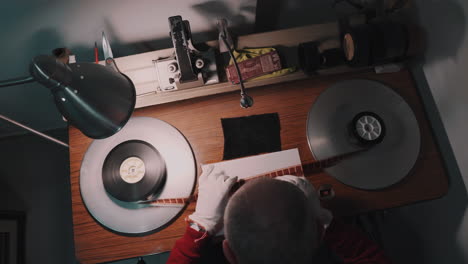a man working at a film studio, works with old film strip.