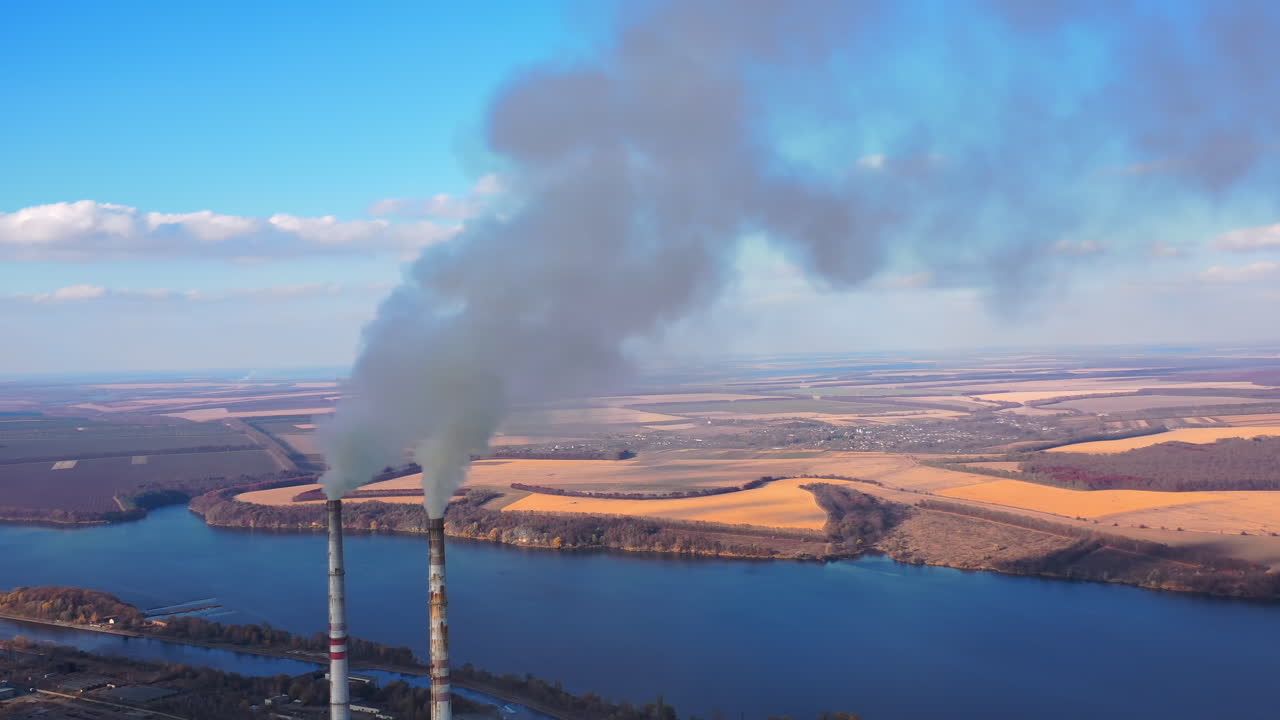 Power plant by the river. Large power plant near a big river