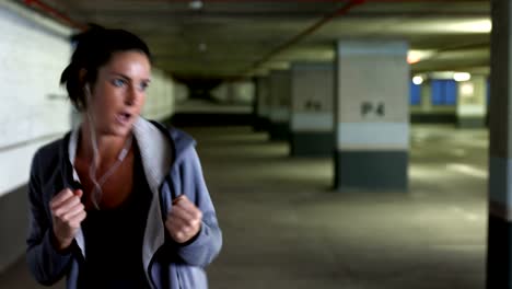 woman practicing boxing exercise at underground car parking lot 4k