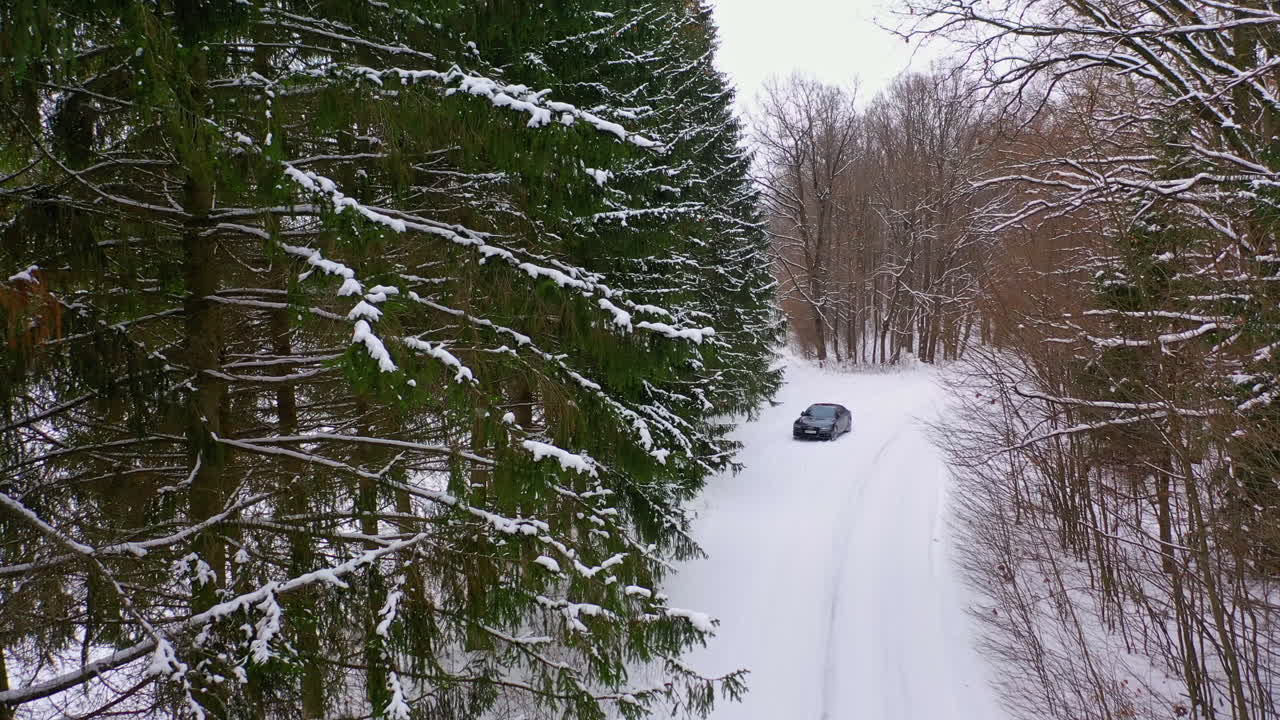 Winter country road with car. Aerial view of winter road and car in forest