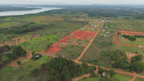 residential land plots divided by roads near the paraná river in countryside aerial view, candelaria, misiones, argentina.