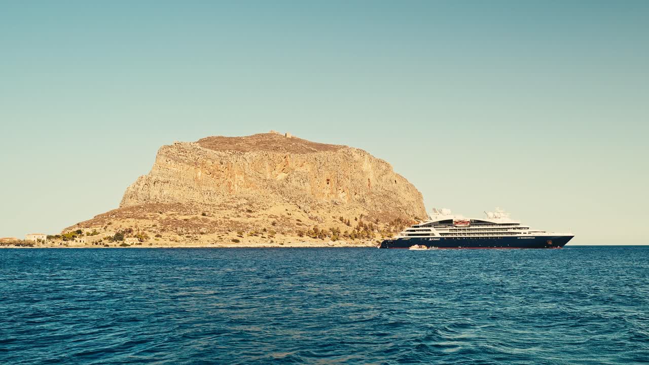 Mediteranean Tourists cruise anchored offshore Greek island