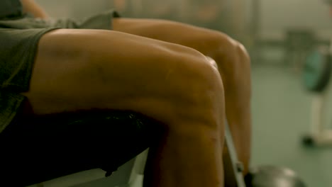 primer plano hombre fuerte con piernas entrenando en el gimnasio
