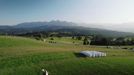 4k drone shot of young couple dancing in front of the mountains