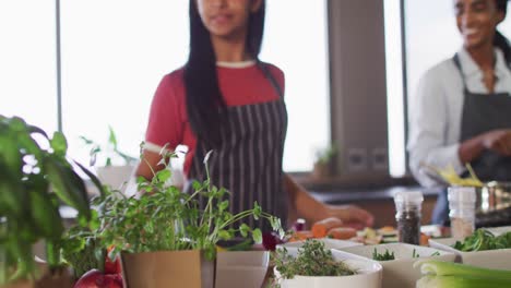 Video-of-happy-diverse-female-friends-preparing-meal