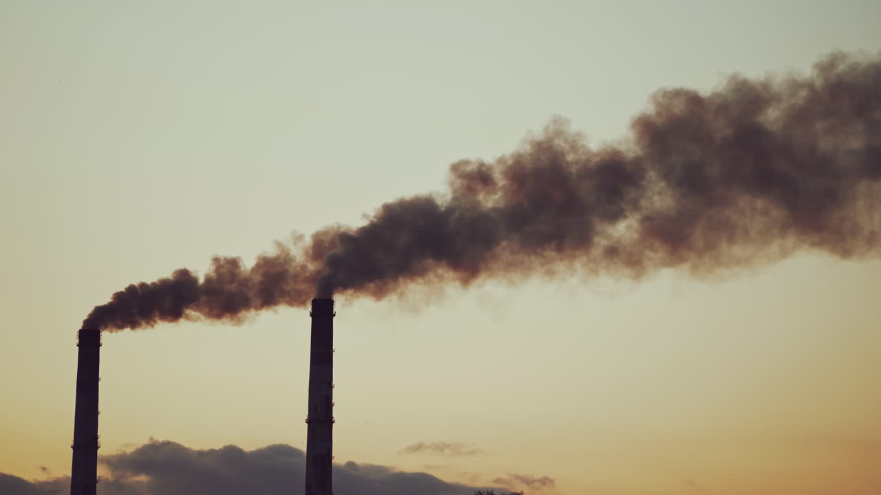 Dioxide air contamination. Industrial smoke from chimney against sunset