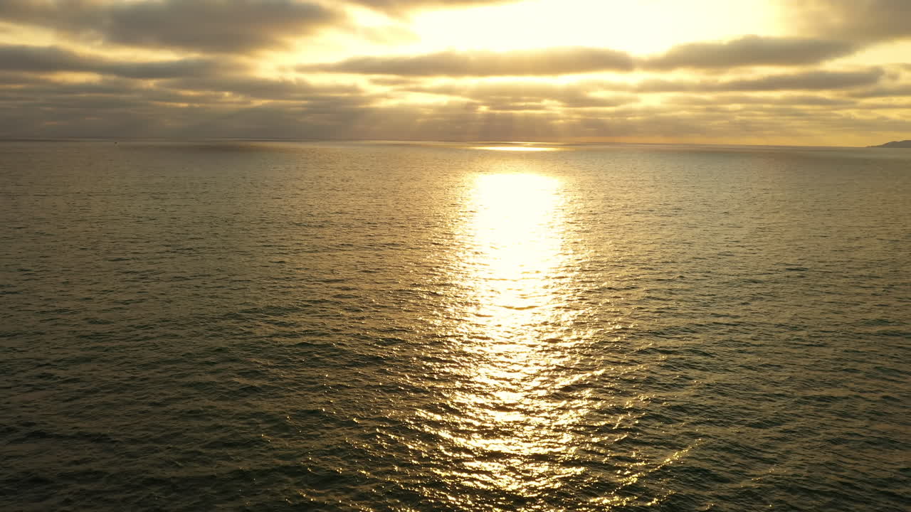 Horizon over water at sunset with shadow and light, ripples on open ocean