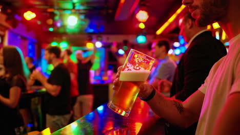people celebrating at a nightclub with beer