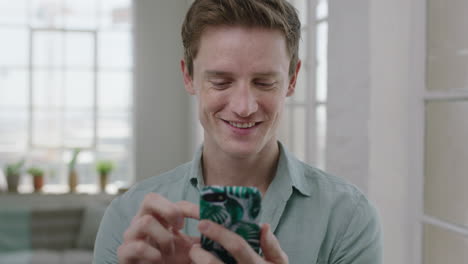 portrait-of-young-red-head-man-texting-browsing-using-smartphone-mobile-technology-smiling-enjoying-social-media-communication