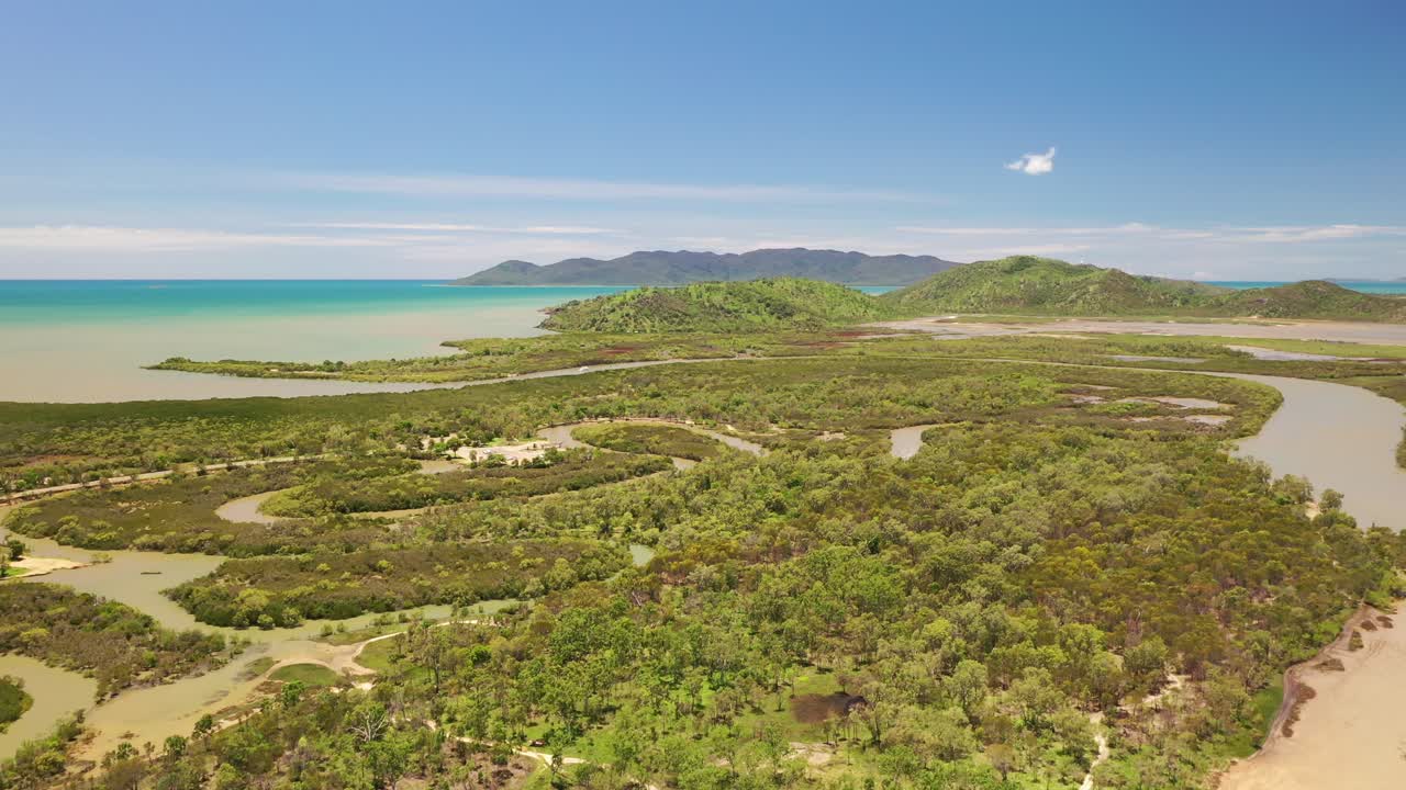 Overflight of tropical mangrove swamp with creeks and island background, Townsville