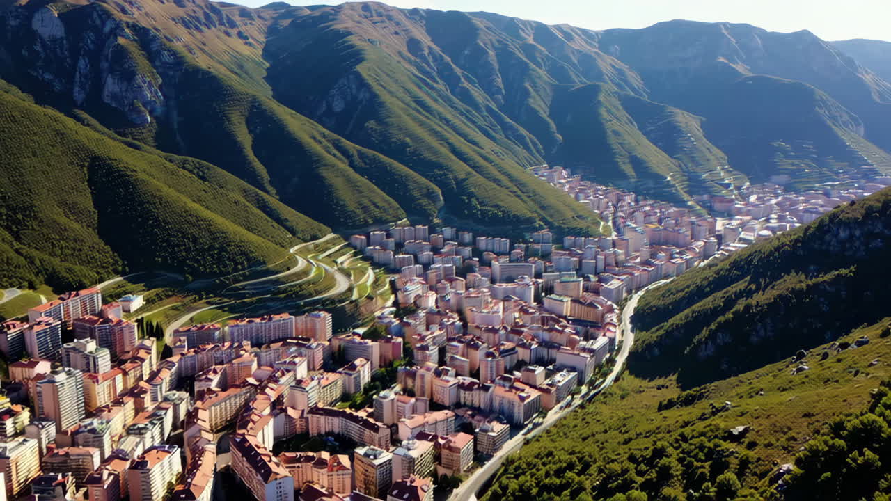 Aerial view of a town nestled in a valley with surrounding mountains