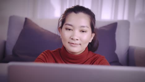 businesswoman on redshirt using the laptop for meeting online and work from home in coronavirus