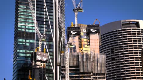 construction of high-rise buildings with cranes in a city