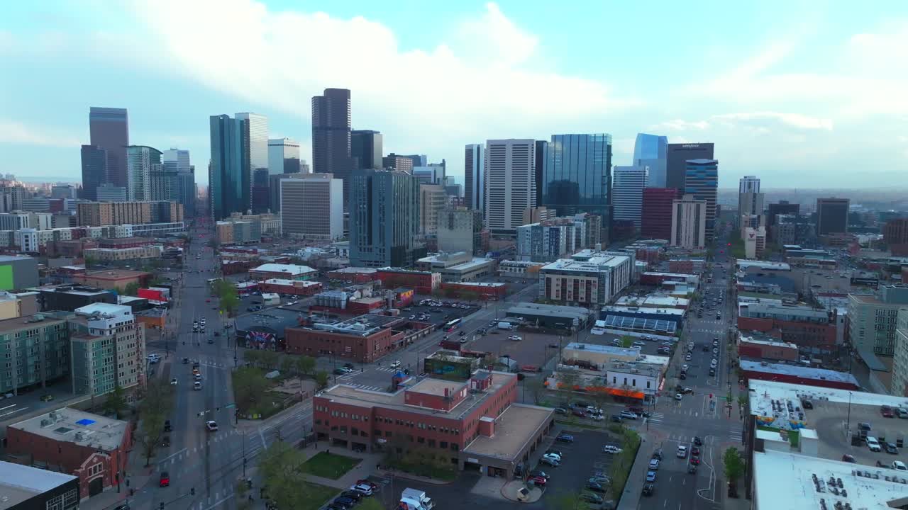 Downtown Denver Rhino art district cityscape businesses buildings aerial drone Colorado tall skyscrapers cars streets spring summer afternoon sunset landscape stormy clouds sunny pan left motion