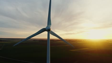 wind turbine at sunset over agricultural fields