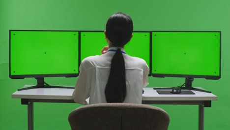 트리플 모니터 설정에서 일하는 여성