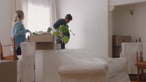 happy-caucasian-family-moving-into-new-home-owners-hanging-picture-decorating-house-together-with-children-young-couple-enjoying-real-estate-property-investment-with-kids-4k-footage