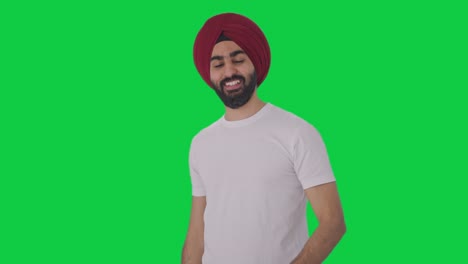 happy sikh indian man calling someone green screen