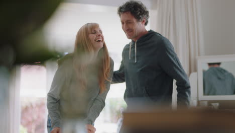 happy young couple dancing at home celebrating having fun weekend morning together enjoying funny dance in bedroom successful relationship celebration 4k footage
