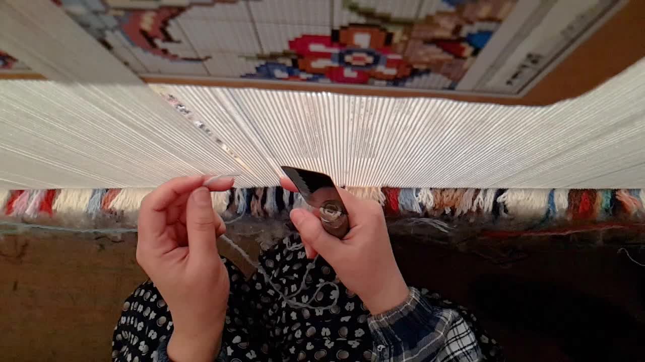 Cartoon pattern design of Persian Carpet rug in Iran and a woman is making handmade carpet by traditional tools by hand colorful design and wonderful natural color dyeing by local people workshop