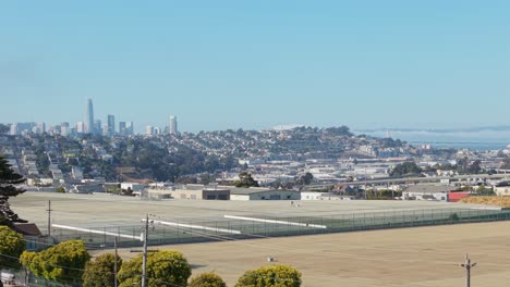 aerial pass over bernal heights reveals a hillside neighborhood with eclectic homes and clear city views.