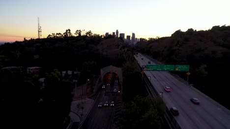 night or dusk aerial over the 110 pasadena harbor freeway and traffic leading into downtown los angeles