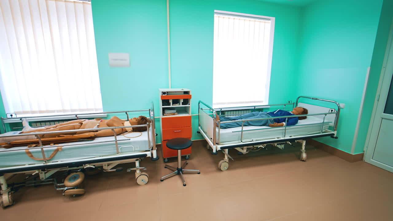 Modern room with human mannequins for medical practices. Medical room with female dummies laying in beds for teaching treatment in university.