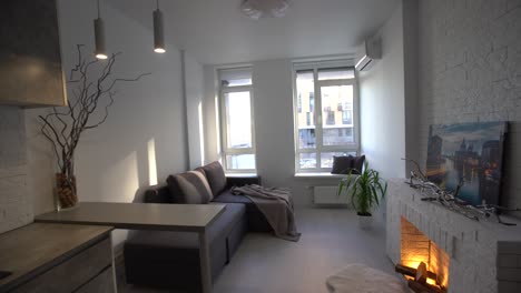 diseño interior de apartamento estudio de estilo loft moderno minimalista de color gris oscuro. cocina, sala de estar, lugar de trabajo