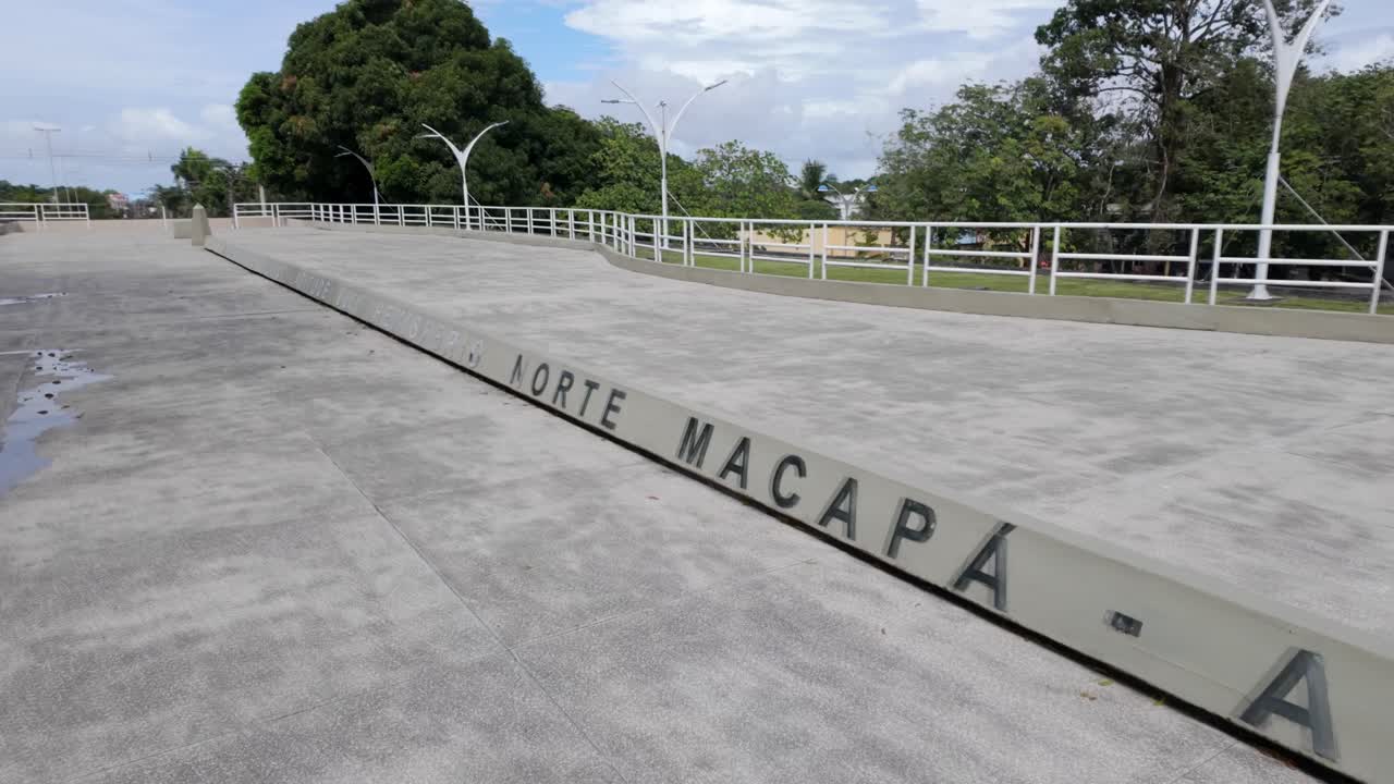 Bustling activity at Macapá's Marco Zero. Visitors gather around this famous equatorial monument to take in the site's cultural significance and sweeping Amazon views