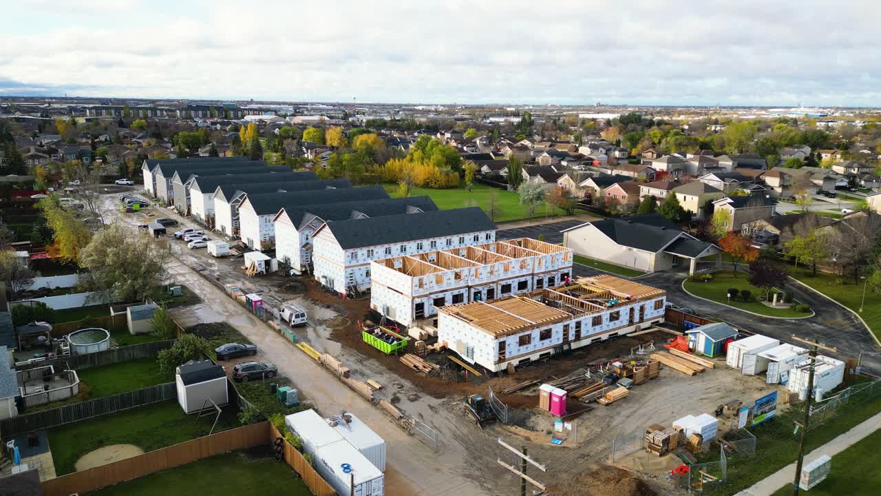Aerial orbit shows volunteers working on Habitat for Humanity homes under construction