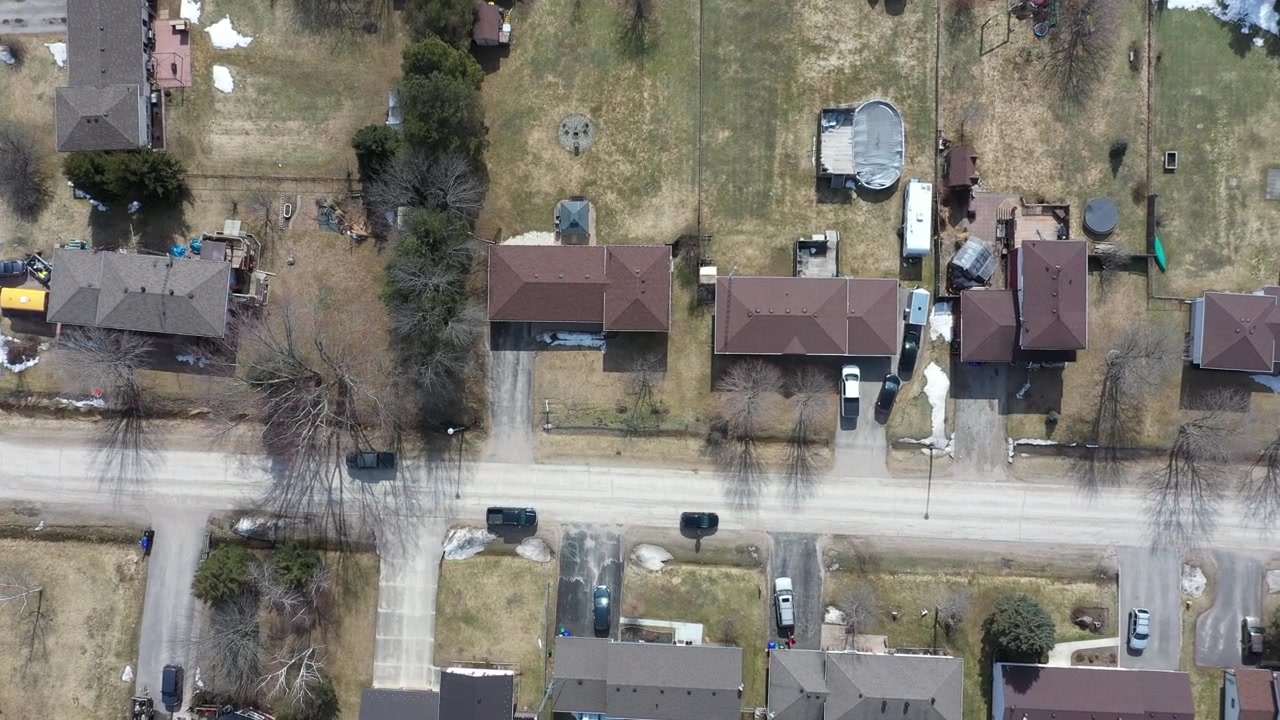 Aerial View of Homes and Roads in a Winter Rural Community. The composition maintains a clear view of the principal subject and This is alternate clip 2 from the same recorded sequence.