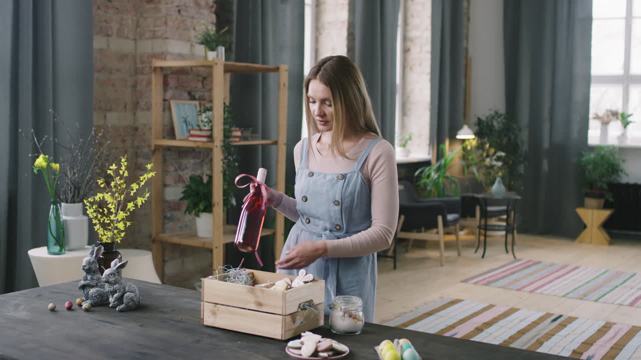 Woman Arranging Gift Basket for Easter