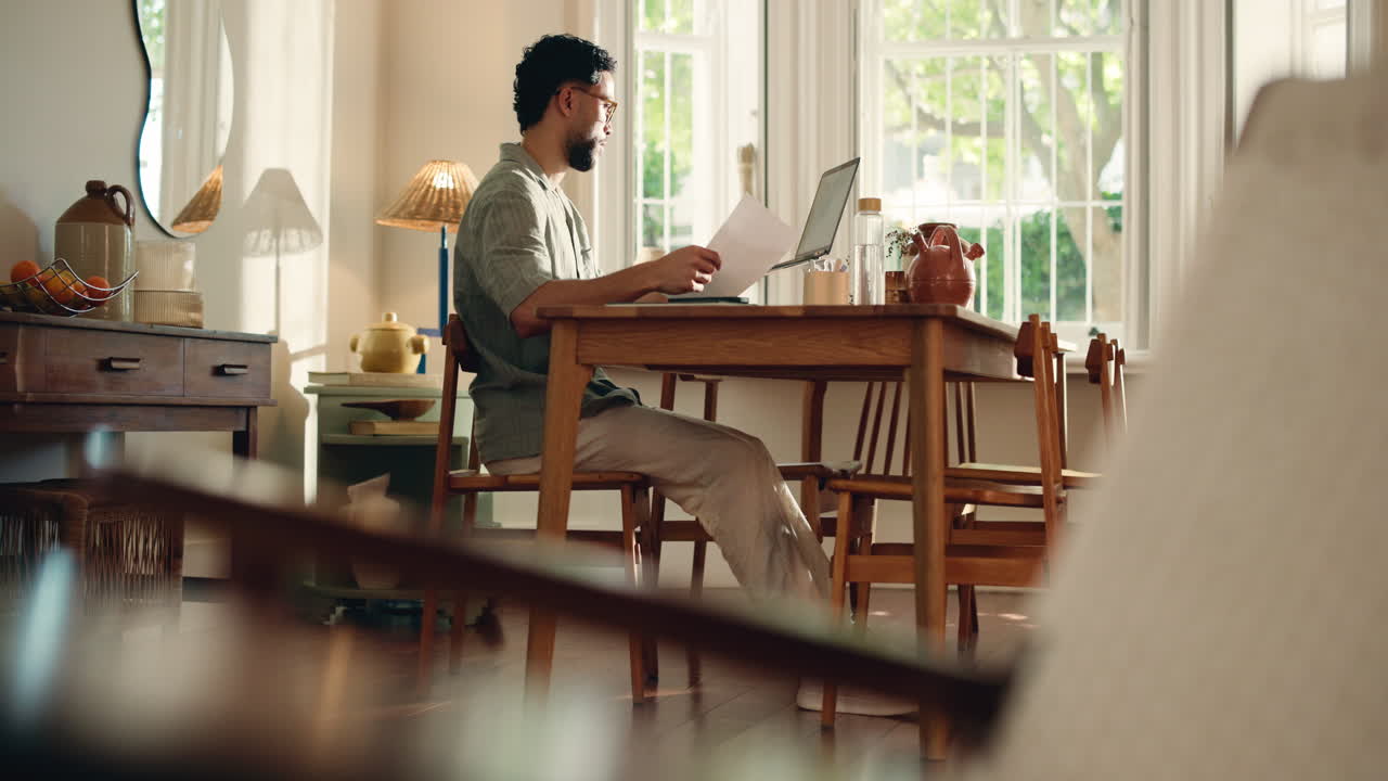 Focused Man Working Remotely at Home Office