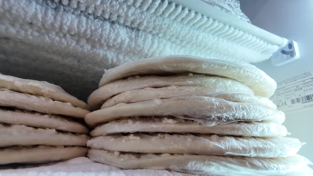 Frozen Dough or Pastries Stacked in a Frosty Freezer