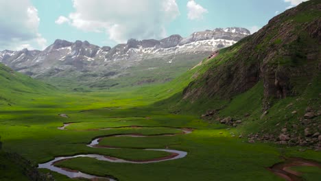 Curved-river-in-mountainous-valley