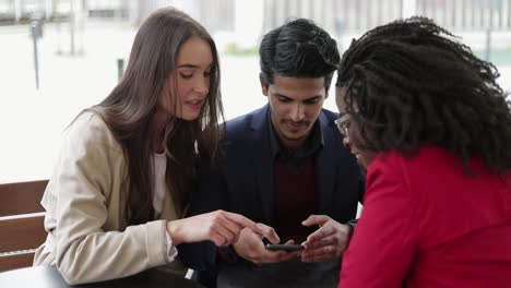 serious man and woman swiping photos on phone, choosing